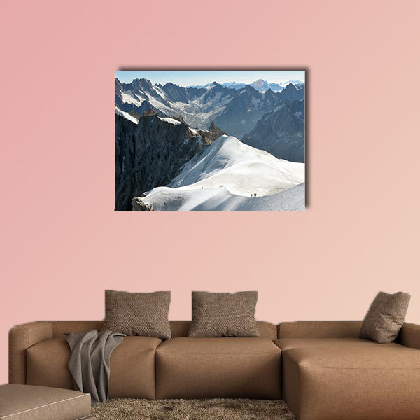View of a range of high Alps and few mountaineers on a snow slope. Multi panel canvas wall art