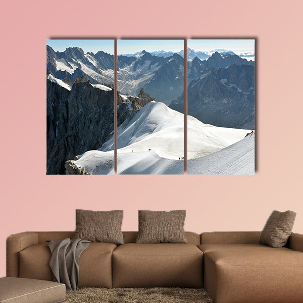 View of a range of high Alps and few mountaineers on a snow slope. Multi panel canvas wall art