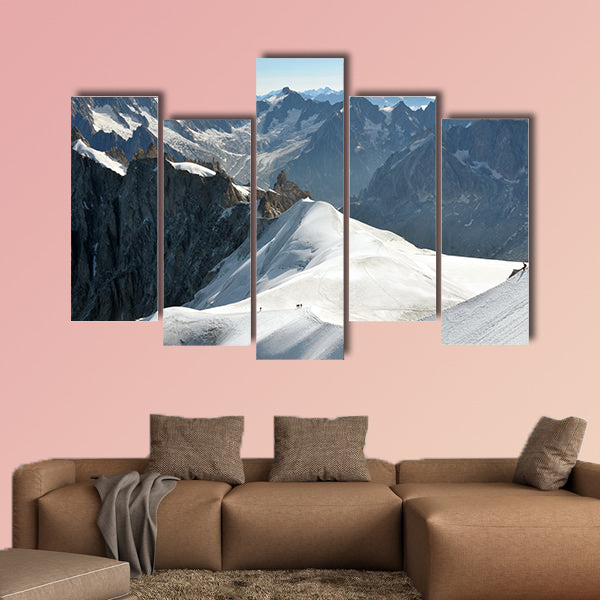 View of a range of high Alps and few mountaineers on a snow slope. Multi panel canvas wall art