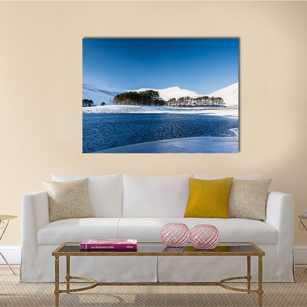A frozen lake in a mountainous snow covered landscape multi panel canvas wall art