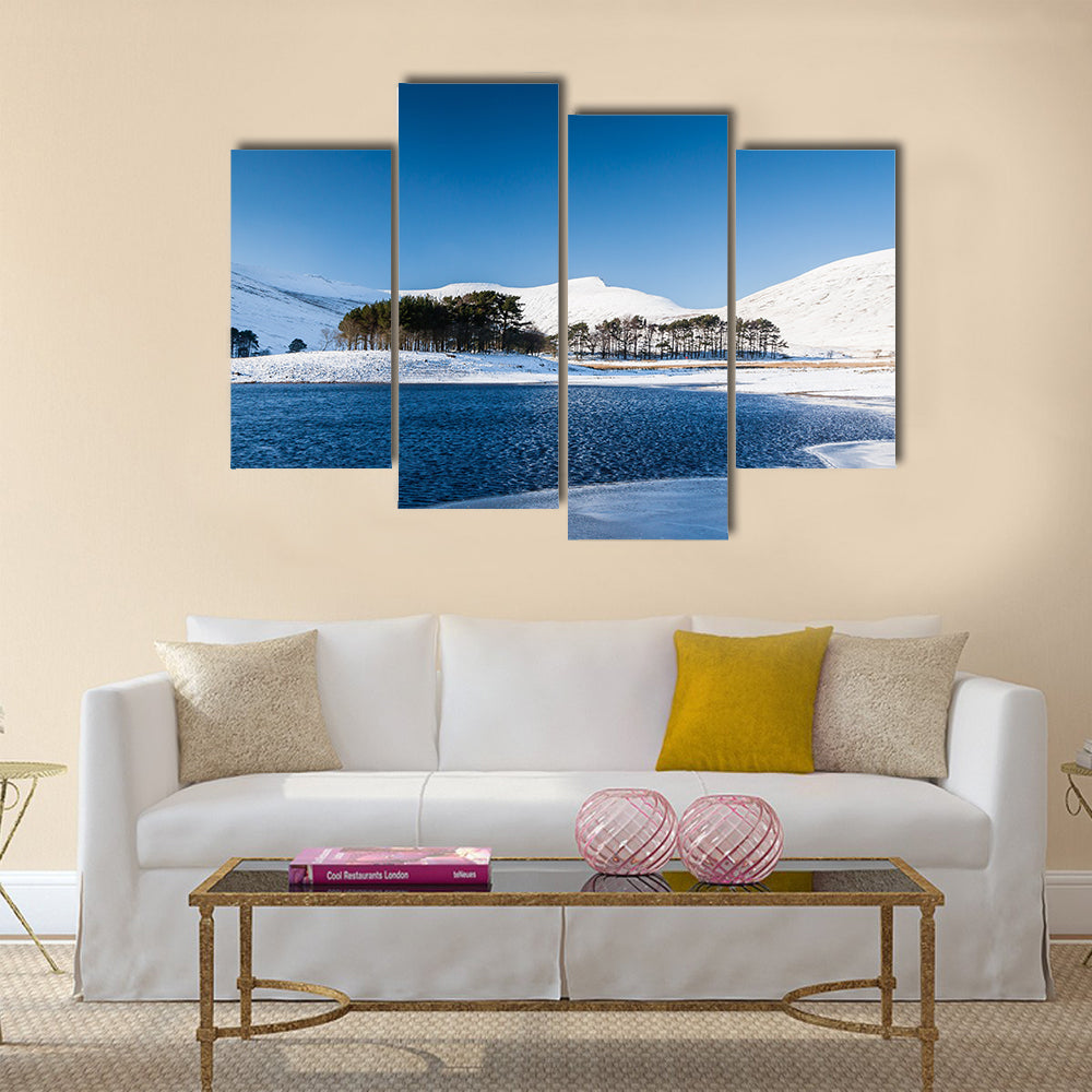A frozen lake in a mountainous snow covered landscape multi panel canvas wall art