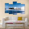 A frozen lake in a mountainous snow covered landscape multi panel canvas wall art