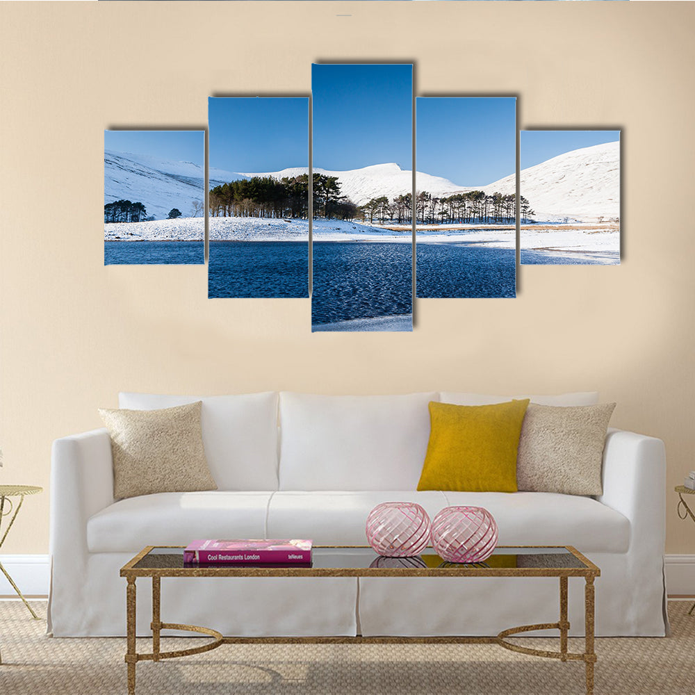 A frozen lake in a mountainous snow covered landscape multi panel canvas wall art