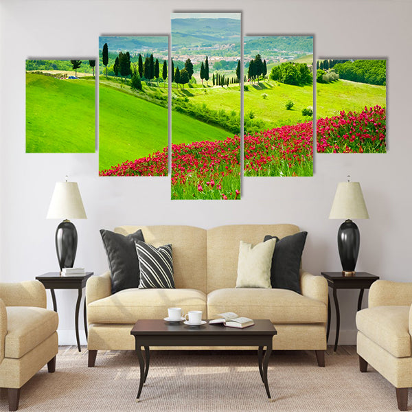 Hill covered by red flowers overlooking a road Multi Panel Canvas Wall Art