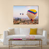 Hot air balloon flying over rock landscape at Cappadocia Turkey, multi panel canvas wall art