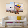 Hot air balloon flying over rock landscape at Cappadocia Turkey, multi panel canvas wall art