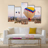 Hot air balloon flying over rock landscape at Cappadocia Turkey, multi panel canvas wall art