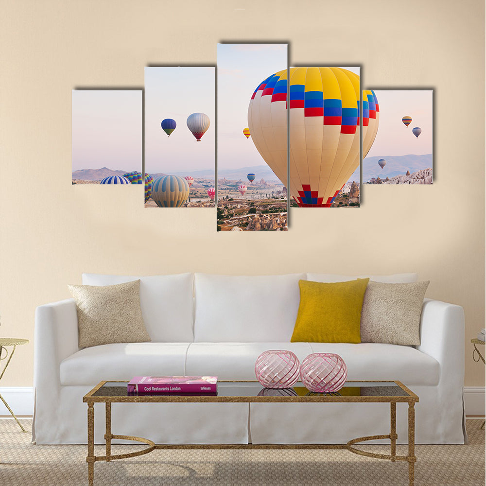 Hot air balloon flying over rock landscape at Cappadocia Turkey, multi panel canvas wall art