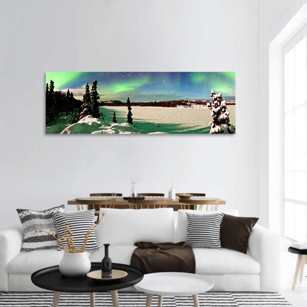 Polar lights forming green arc over snowy winter landscape panoramic canvas wall art