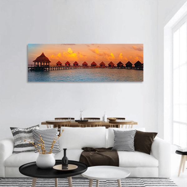Houses on piles on water at the time sunset panoramic canvas wall art