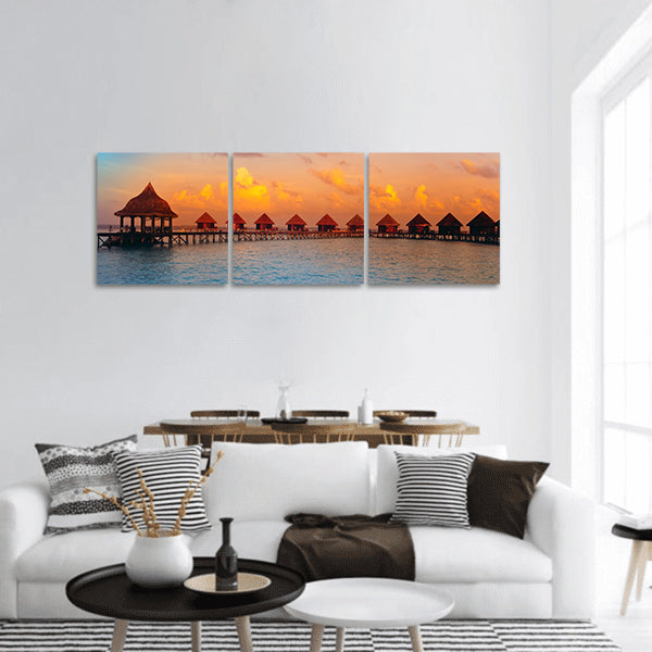 Houses on piles on water at the time sunset panoramic canvas wall art