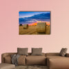 End of day over field with hay bale in Hungary multi panel canvas wall art