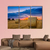 End of day over field with hay bale in Hungary multi panel canvas wall art