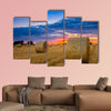 End of day over field with hay bale in Hungary multi panel canvas wall art