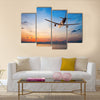 Airplane flying above tropical sea at sunset multi panel canvas wall art