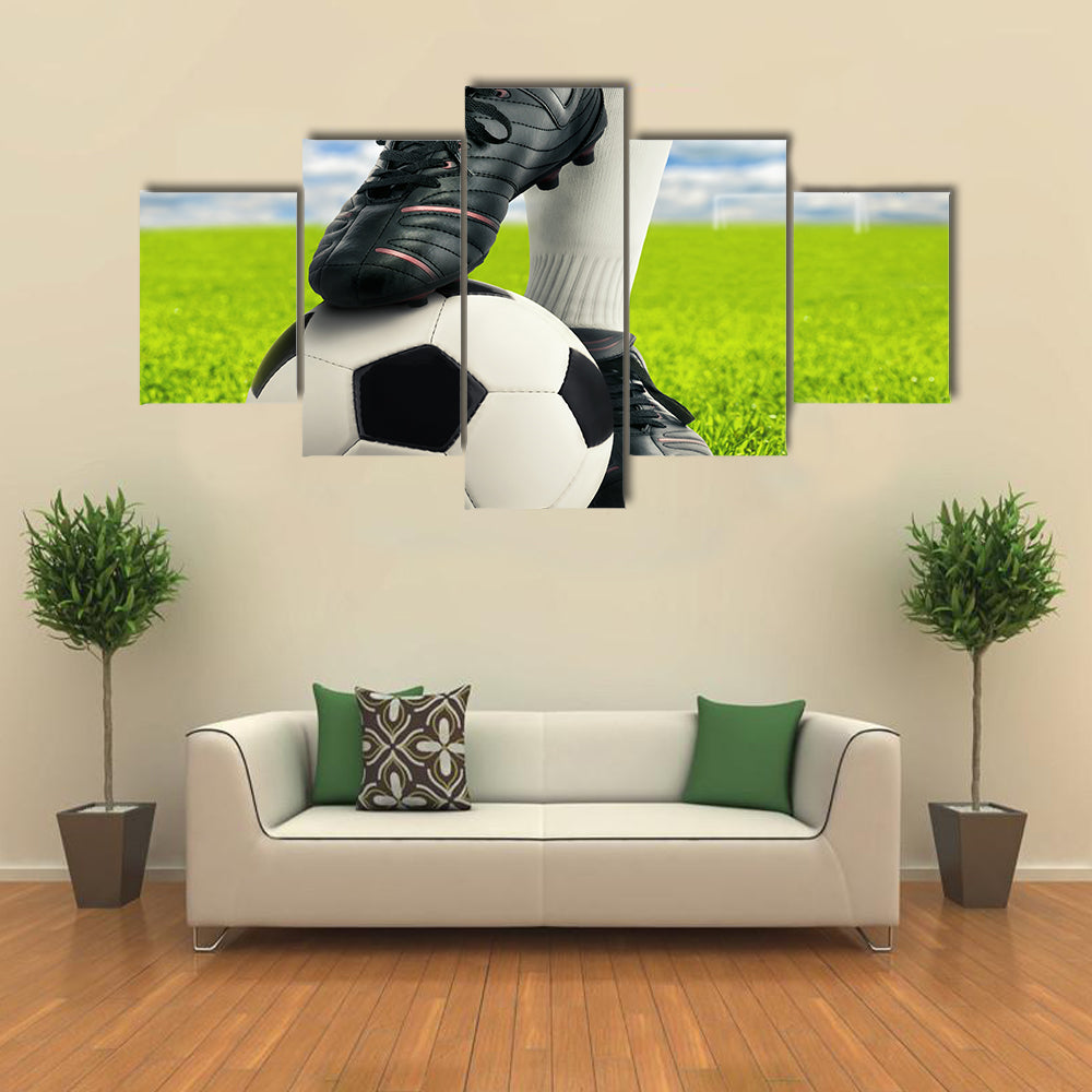 Soccer player on green grass Multi panel canvas wall art