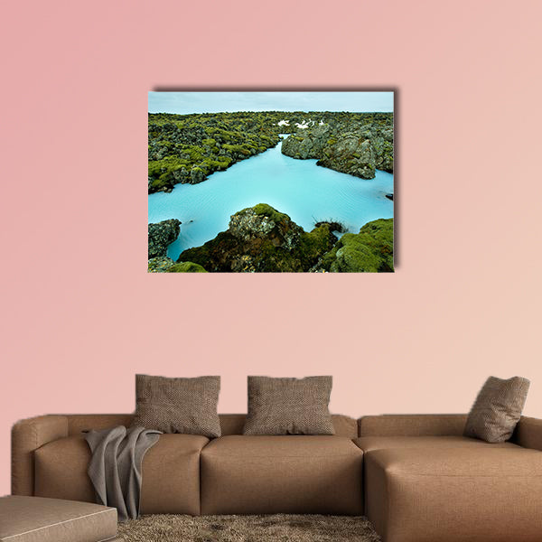 The blue water between the lava stones of Iceland canvas wall art
