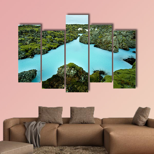 The blue water between the lava stones of Iceland canvas wall art