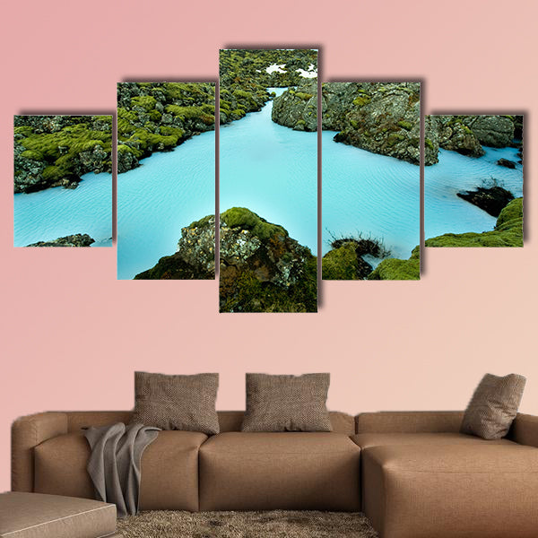 The blue water between the lava stones of Iceland canvas wall art