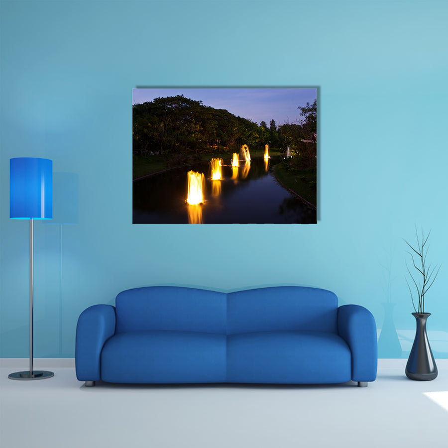 Fountain in garden at night time multi panel canvas wall art