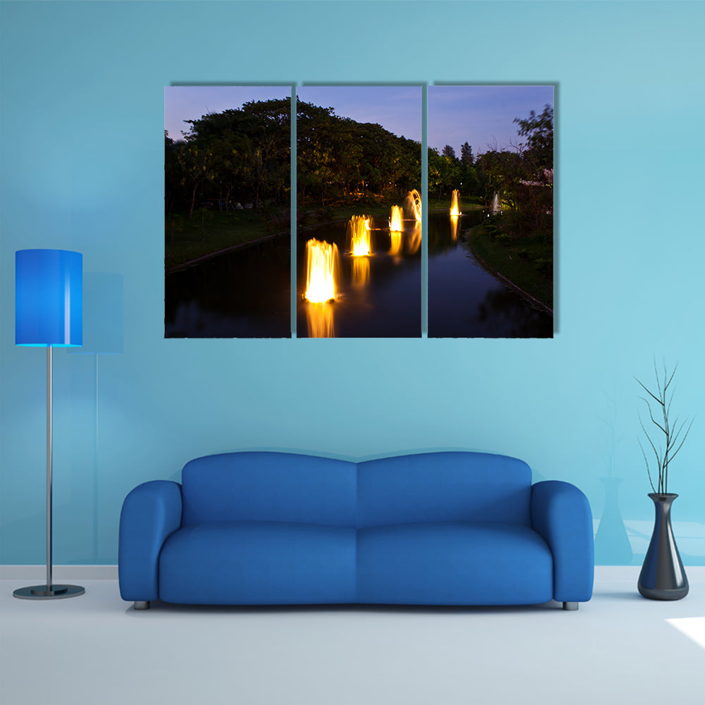 Fountain in garden at night time multi panel canvas wall art