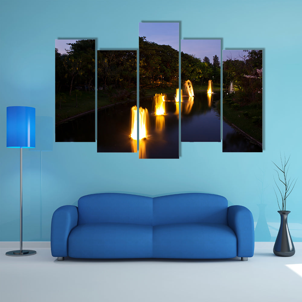 Fountain in garden at night time multi panel canvas wall art