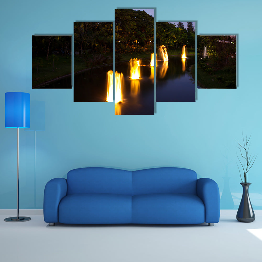 Fountain in garden at night time multi panel canvas wall art