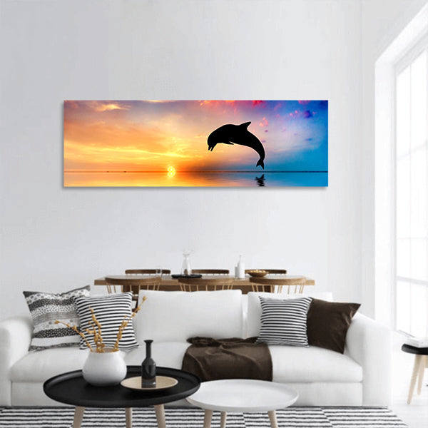 Beautiful calm ocean at sunset. Dolphin jumping silhouette panoramic canvas wall art