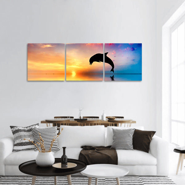 Beautiful calm ocean at sunset. Dolphin jumping silhouette panoramic canvas wall art
