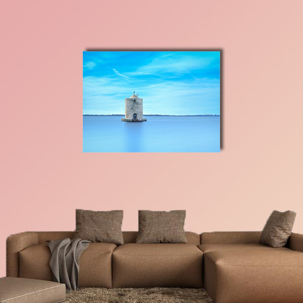 Old spanish windmill in a blue lagoon Molino spagnolo canvas wall art