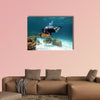 Young Man Scuba Diver between Water Surface near a turtle Multi panel canvas wall art