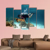 Young Man Scuba Diver between Water Surface near a turtle Multi panel canvas wall art