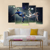 Two football players in jump to strike the ball at the stadium under rain Multi panel canvas wall art