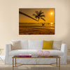 Sunset with palm and longtail boats on tropical beach. multi panel canvas wall art