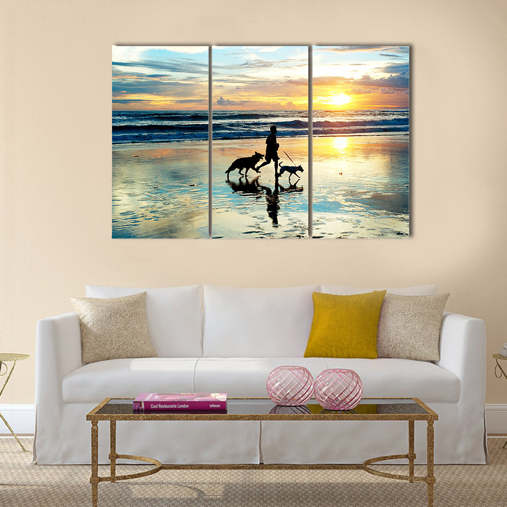 A Man With Dogs Running On Bali Island On Sunset, Indonesia Multi Panel Canvas Wall Art