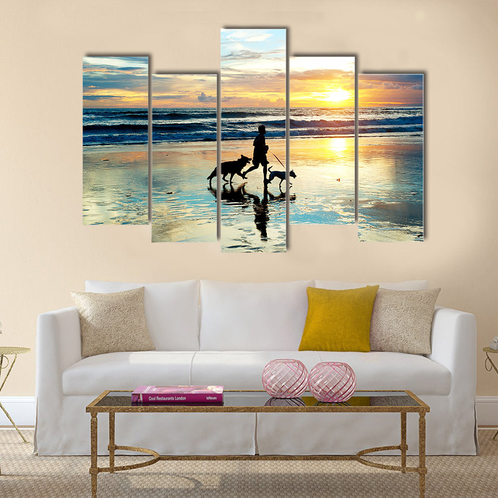 A Man With Dogs Running On Bali Island On Sunset, Indonesia Multi Panel Canvas Wall Art