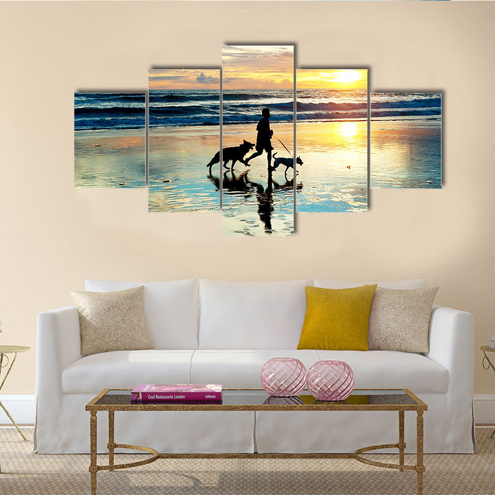 A Man With Dogs Running On Bali Island On Sunset, Indonesia Multi Panel Canvas Wall Art