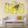 Monarch butterfly on yellow flower Multi Panel Canvas Wall Art