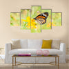 Monarch butterfly on yellow flower Multi Panel Canvas Wall Art