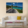 Asphalt road along tropical coastline with palm trees and buildings on a side multi panel canvas wall art