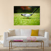 Golf ball on tee in front of driver Multi Panel Canvas Wall Art