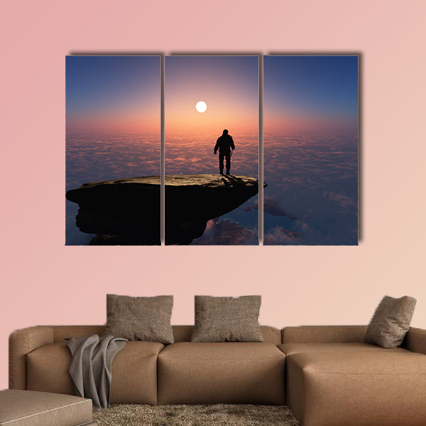 Silhouette of a man on a rock Multi panel canvas wall art