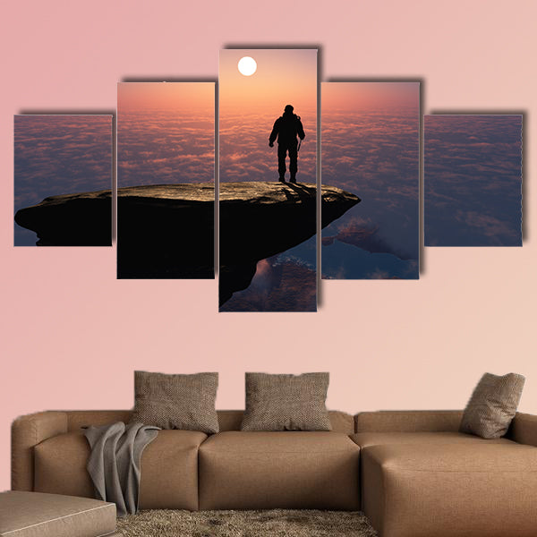 Silhouette of a man on a rock Multi panel canvas wall art