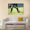 The strong white legs of a sportive young woman playing Hockey sport Multi panel canvas wall art