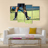 The strong white legs of a sportive young woman playing Hockey sport Multi panel canvas wall art