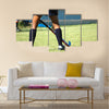 The strong white legs of a sportive young woman playing Hockey sport Multi panel canvas wall art