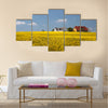 yellow rape field and farmhouses Multi Panel Canvas Wall Art