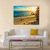 Young happy couple enjoying a beautiful sunset multi panel canvas wall art