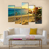 Young happy couple enjoying a beautiful sunset multi panel canvas wall art