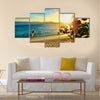 Young happy couple enjoying a beautiful sunset multi panel canvas wall art